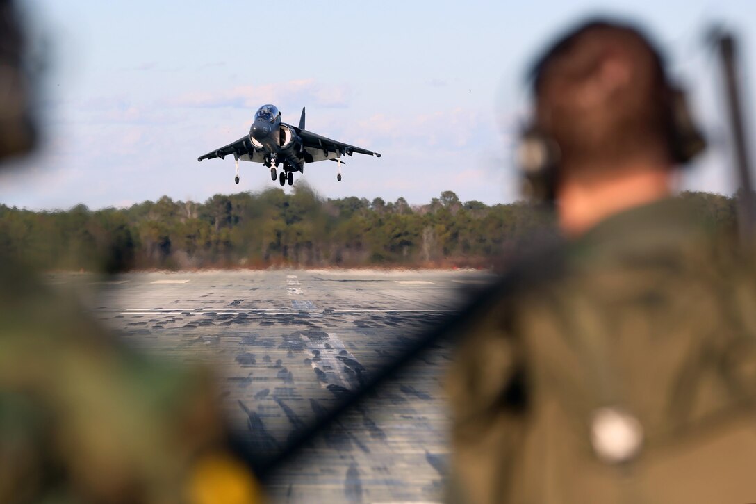 Instructor pilots with Marine Attack Training Squadron 203, Marine Aircraft Group 14, 2nd Marine Aircraft Wing, observe an AV-8B Harrier landing on the runway at Marine Corps Auxiliary Landing Field Bogue, N.C., Jan. 18, 2017. As the only site on the East Coast that offers Marine Corps pilots field carrier landing practice, the airfield is essential to improving expeditionary mission readiness by training pilots to land on aircraft carriers. The airfield consists of runways constructed from aluminum panels, which can be disassembled and reconstructed anywhere in the world in a matter of days. (U.S. Marine Corps photo by Cpl. Mackenzie Gibson/ Released)