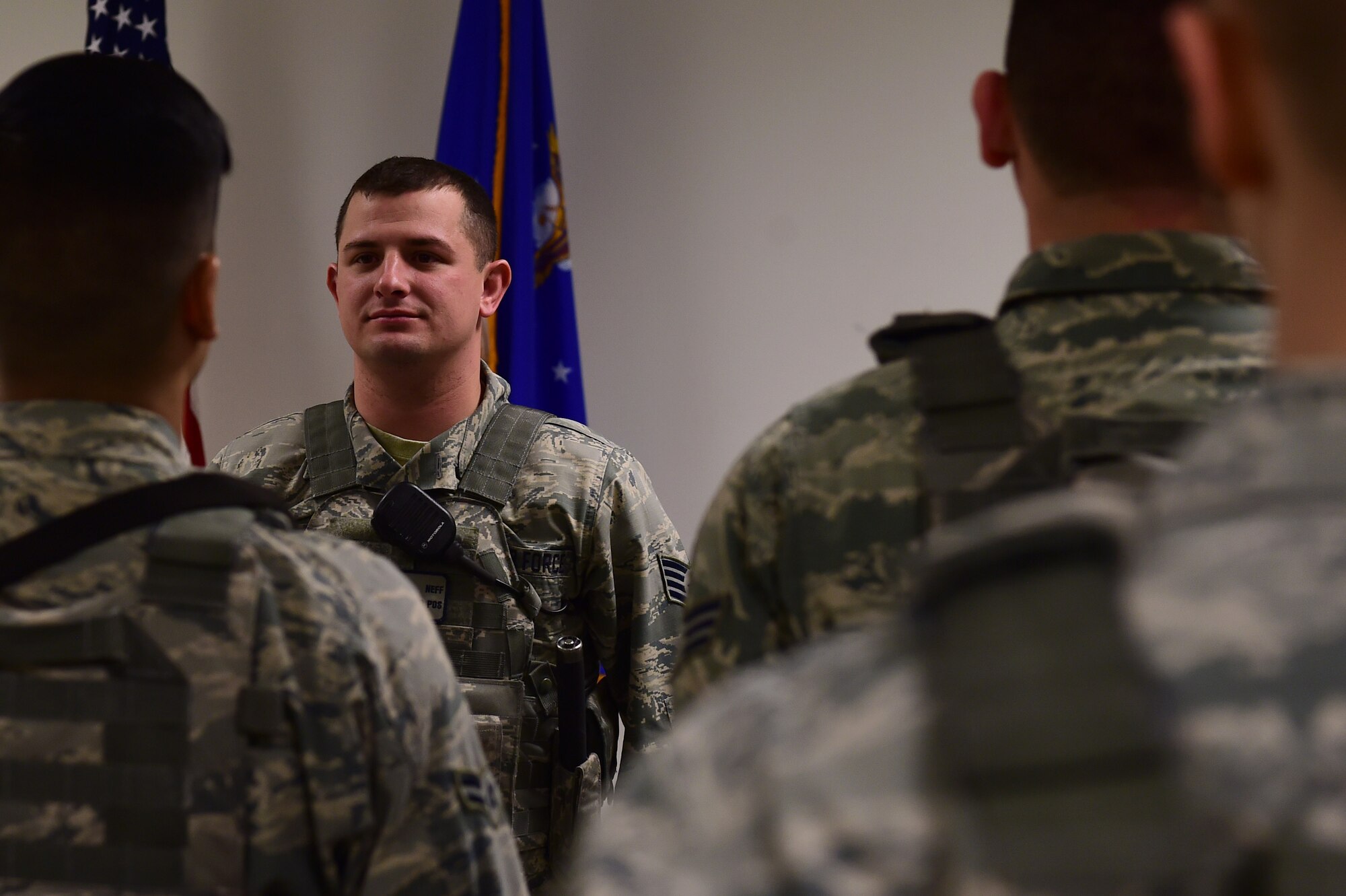 Staff Sgt. Bryce Neff, 460th Security Forces Squadron flight chief, debriefs Airmen coming off duty during shift change Jan. 13, 2017, on Buckley Air Force Base, Colo. Neff was highlighted by Col. David Miller Jr., 460th Space Wing commander, for his exceptional performance with ensuring Installation Readiness through numerous exercises and assessments.