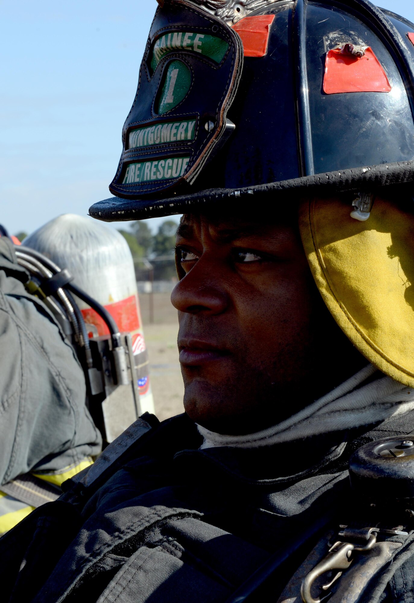 Joseph Manuel, Montgomery Fire Department firefighter trainee, sits on the ground before training on a simulated fire inside a building on Maxwell Air Force Base, Ala., Jan. 13, 2017. The trainees go through a series of possible situations to prepare them once they become a firefighter. The MFD utilized a fire training building on the installation to give the trainees an opportunity to experience fighting a house fire with individuals trapped inside. (U.S. Air Force photo/Senior Airman Tammie Ramsouer)