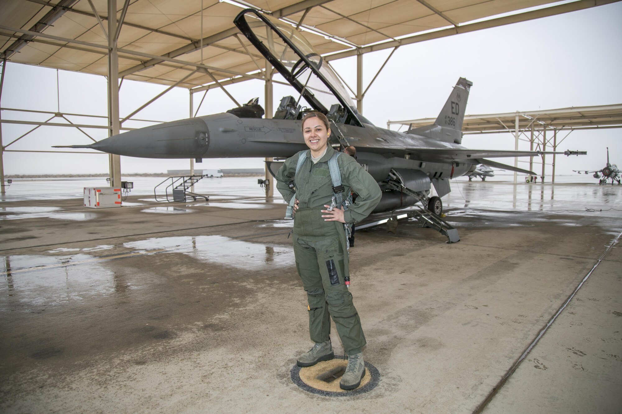 Staff Sgt. Raquel Caramanno, 412th Medical Group, poses for a photo before her incentive flight aboard an F-16 Fighting Falcon piloted by Brig. Gen. Carl E. Schaefer, 412th Test Wing Commander. Caramanno was selected as one of the U.S. Air Force's 12 Outstanding Airmen of the Year for 2016. (U.S. Air Force photo by Christian Turner)