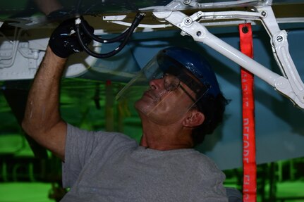 Rudy Olivarez, a Corrosion Control Specialist in the 12th Maintenance Group, applies paint to the landing gear of a T-38C Talon at Joint Base San Antonio-Randolph, Texas, Jan. 13, 2017.  Members of the corrosion control shop are changing the plane’s color scheme from two-tone gray to heritage blue, a scheme that was used by the 435th Fighter Training Squadron 40 years ago, ahead of a reunion of pilots that trained for fighter fundamentals after Jan. 1, 1977. (U.S. Air Force photo/Randy Martin) 