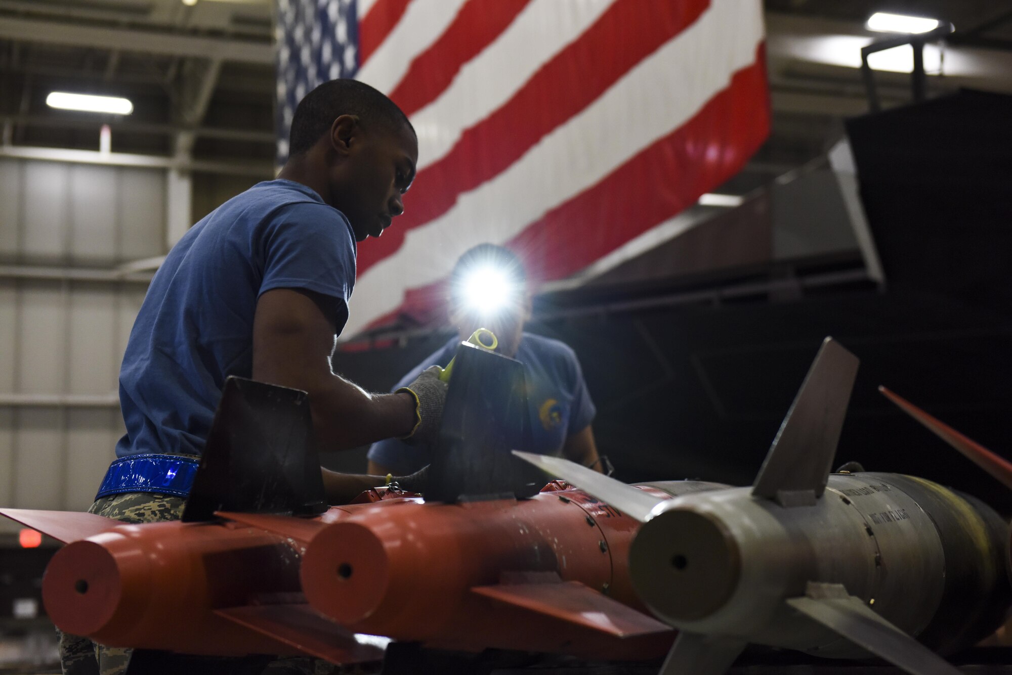 U.S. Air Force Airman 1st Class Chase Davis, a weapons load crew 3-member assigned to the 13th Aircraft Maintenance Unit, examines a GBU-38 during the fourth quarter load competition at Whiteman Air Force Base, Mo., Jan. 6, 2017. Every three months the most proficient crews from each aircraft maintenance unit within the 509th and 131st Aircraft Maintenance Squadrons compete for the Load Crew of the Quarter award.