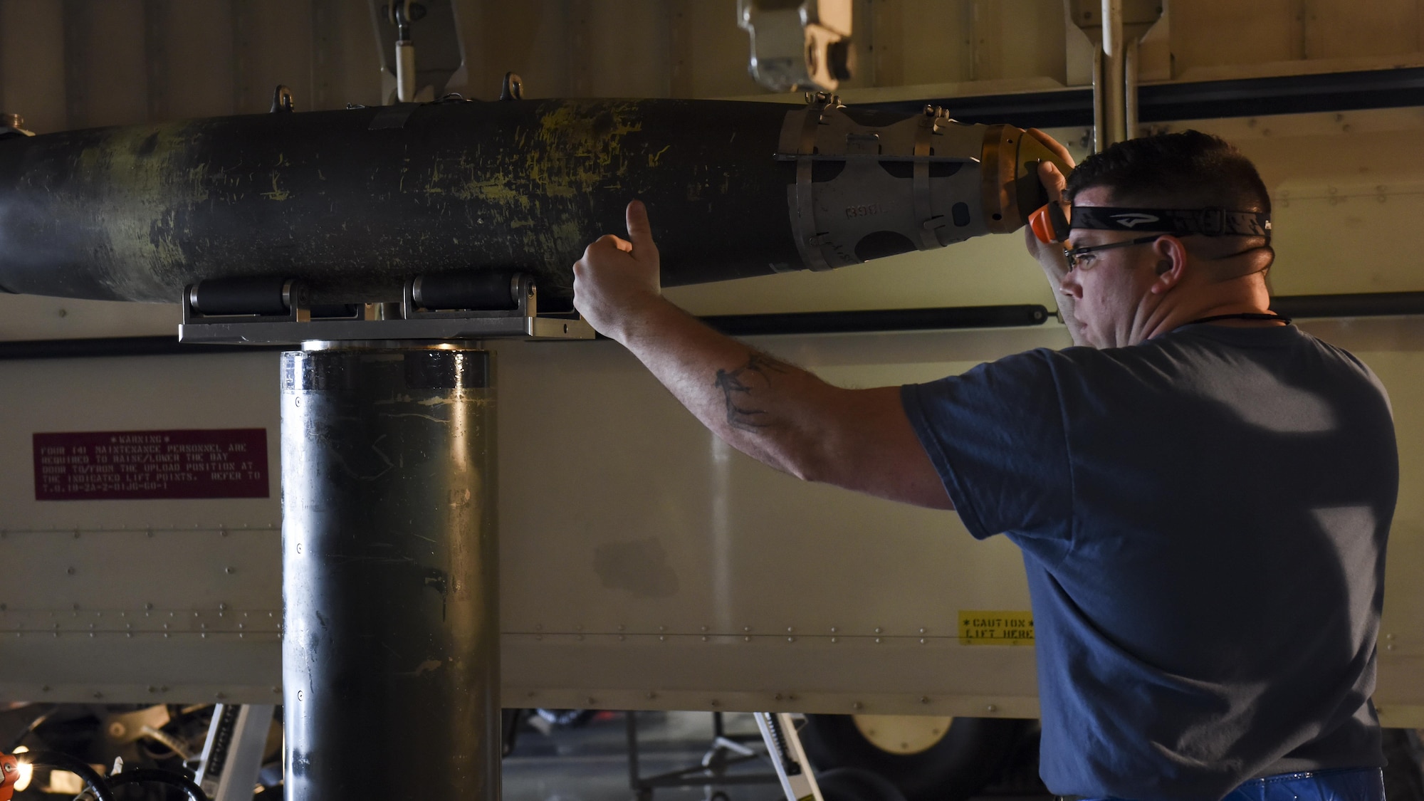 U.S. Air Force Staff Sgt. Jesse McCullough, a weapons load crew team chief assigned to
the 13th Aircraft Maintenance Unit, assists in positioning a GBU-38 during a fourth quarter
load competition at Whiteman Air Force Base, Mo., Jan. 6, 2017. Every three months
the most proficient crew from each aircraft maintenance unit within the 509th and 131st
Aircraft Maintenance Squadrons competes for the Load Crew of the Quarter award.