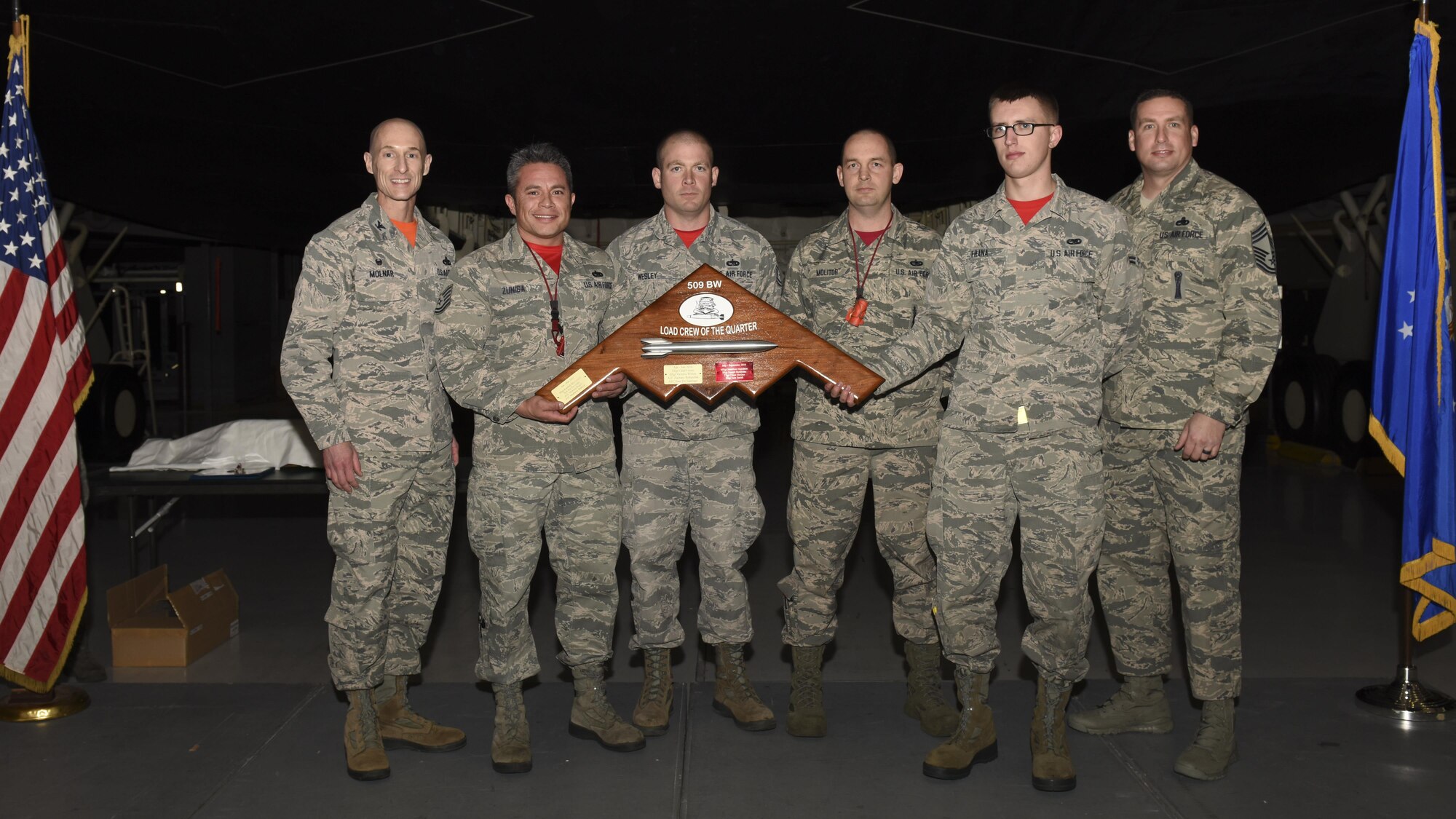 Members of the 131st Aircraft Maintenance Squadron (AMXS) are presented with the 509th MXG Load Crew of the Quarter award for winning the fourth quarter load competition at Whiteman Air Force Base, Mo., Jan. 6, 2017. The 131st AMXS won with a time of 30 minutes 30 seconds, and zero discrepancies noted.