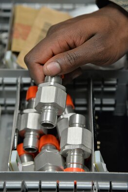 Senior Airman Shaquille Stephens, 341st Missile Maintenance Squadron maintenance technician, holds a quick disconnect fitting Jan. 17, 2017, at Malmstrom Air Force Base, Mont. The duties of tool room technicians are to ensure missile maintenance Airmen have the appropriate tools needed while they work in the missile field. (U.S. Air Force photo/Airman 1st Class Daniel Brosam)