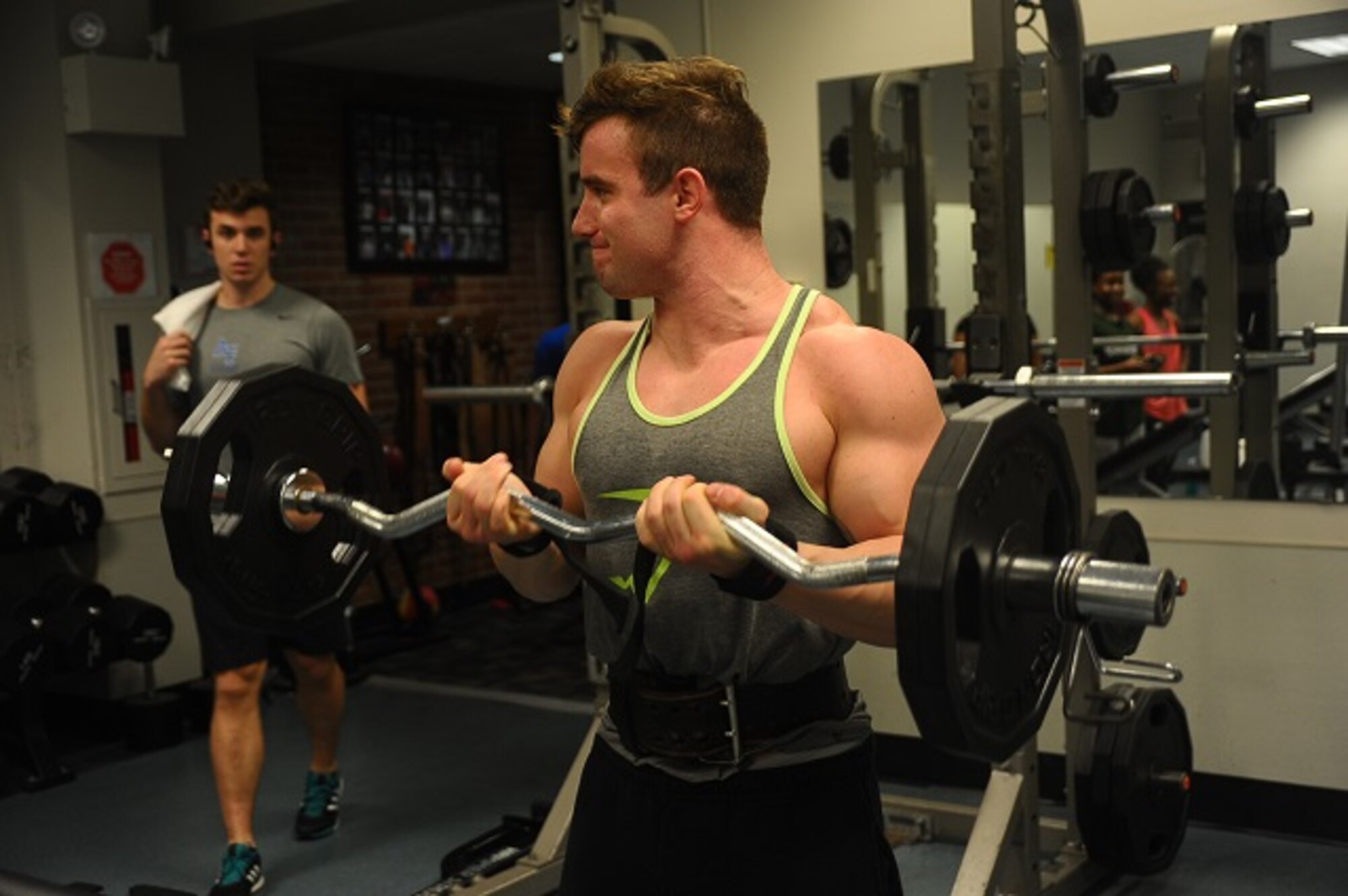 Senior Airman Zachary Sellers, 49th Fighter Training Squadron Aviation Resource Manager, curls the weight bar during his workout routine Jan. 18, 2017, at the Fitness Center on Columbus Air Force Base, Mississippi. Besides its physical health benefits, working out has the benefit of increased focus, a better state of mind and a higher degree of readiness. (U.S. Air Force photo by Senior Airman John Day)