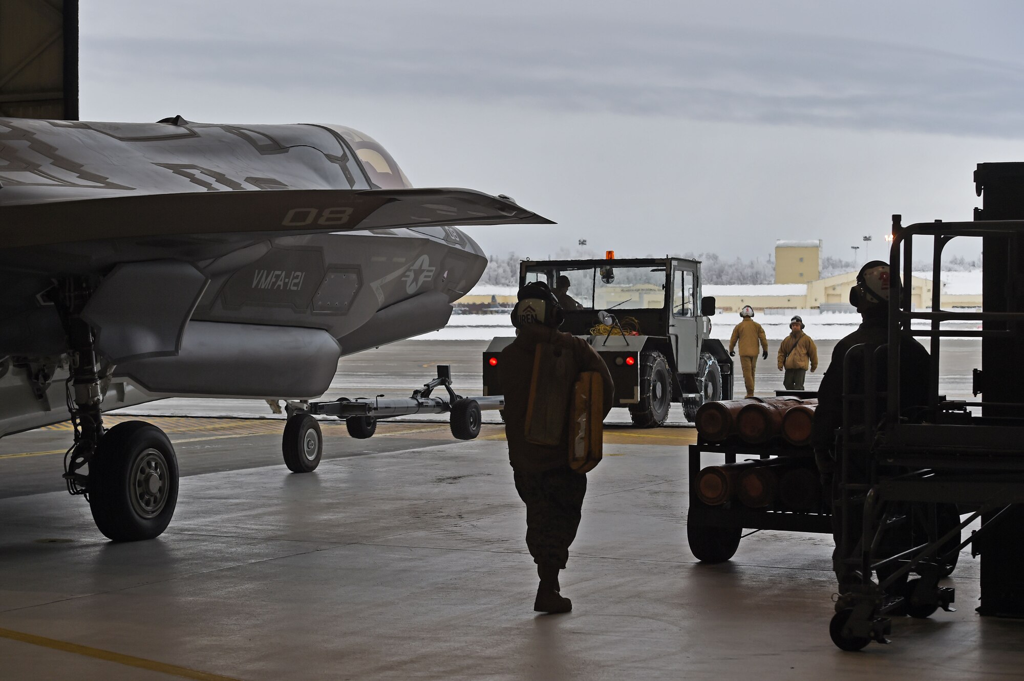 Marines assigned to Marine Fighter Attack Squadron (VMFA) 121, 3rd Marine Aircraft Wing, move F-35Bs in a hangar, Jan. 13, 2017, during a stop on Joint Base Elmendorf-Richardson, Alaska, en route to Marine Corps Air Station Iwakuni, Japan. VMFA-121 is the first operational F-35B squadron in the Marine Corps, with its relocation to 1st Marine Aircraft Wing at Iwakuni. The F-35B was developed to replace the Marine Corps’ F/A-18 Hornet, AV-8B Harrier and EA- 6B Prowler. The Short Take-off Vertical Landing (STOVL) aircraft is a true force multiplier. The unique combination of stealth, cutting-edge radar and sensor technology, and electronic warfare systems bring all of the access and lethality capabilities of a fifth-generation fighter, a modern bomber, and an adverse-weather, all-threat environment air support platform.