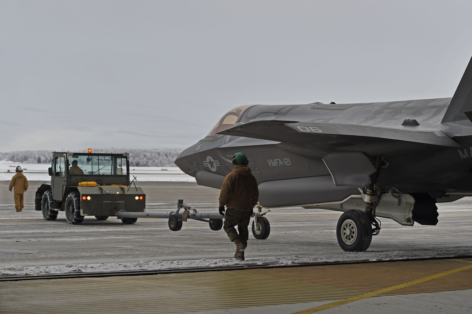 Marines assigned to Marine Fighter Attack Squadron (VMFA) 121, 3rd Marine Aircraft Wing, move F-35Bs in a hangar, Jan. 13, 2017, during a stop on Joint Base Elmendorf-Richardson, Alaska, en route to Marine Corps Air Station Iwakuni, Japan. VMFA-121 is the first operational F-35B squadron in the Marine Corps, with its relocation to 1st Marine Aircraft Wing at Iwakuni. The F-35B was developed to replace the Marine Corps’ F/A-18 Hornet, AV-8B Harrier and EA- 6B Prowler. The Short Take-off Vertical Landing (STOVL) aircraft is a true force multiplier. The unique combination of stealth, cutting-edge radar and sensor technology, and electronic warfare systems bring all of the access and lethality capabilities of a fifth-generation fighter, a modern bomber, and an adverse-weather, all-threat environment air support platform.