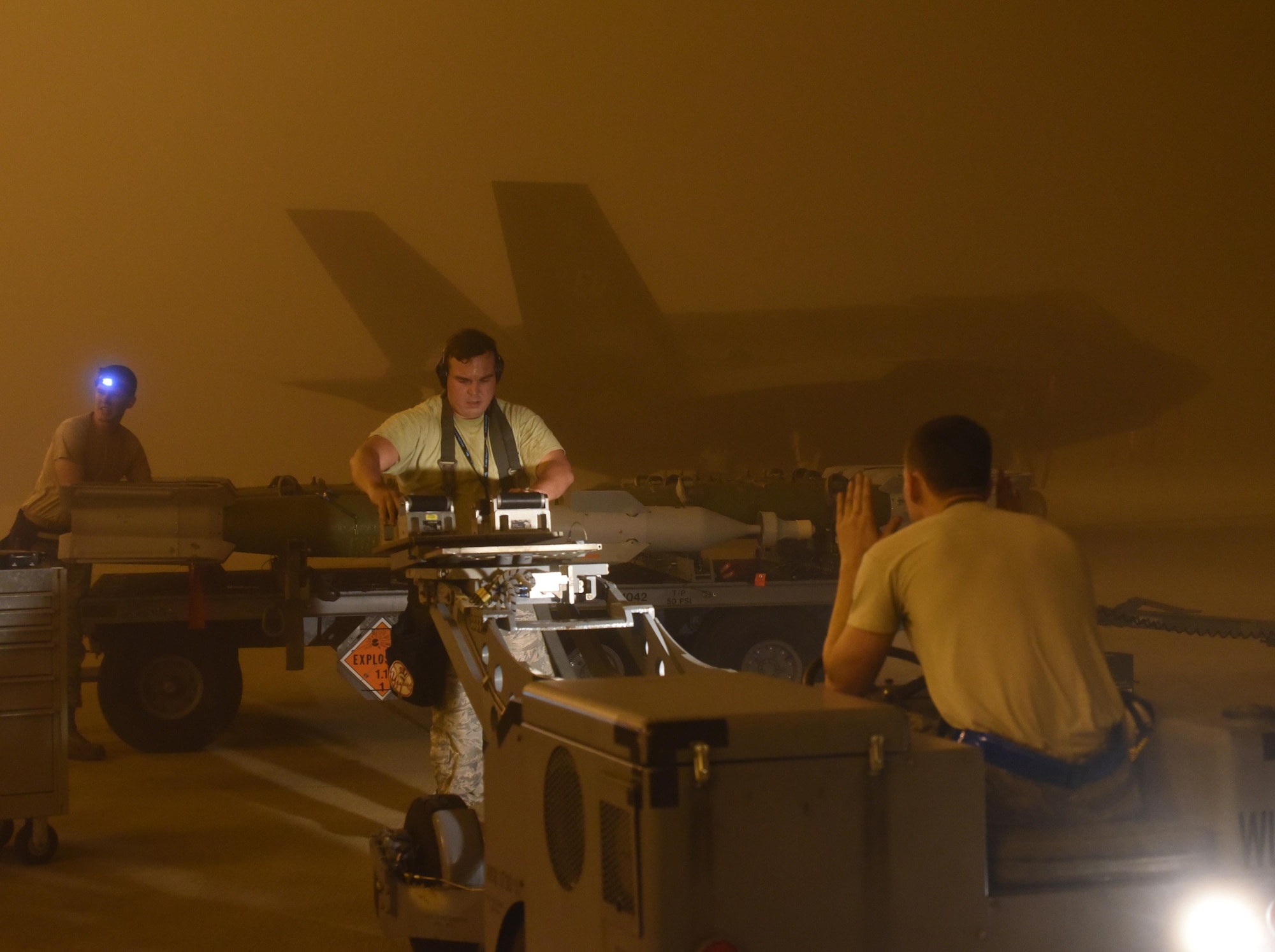 A U.S. Air Force weapons load crew assigned to the 33rd Aircraft Maintenance Squadron transports a live GBU-12 to an F-35A January 18, 2017, at Eglin Air Force Base, Florida. The 33rd Fighter Wing loaded and released the Air Education and Training Command’s first live bombs from an F-35A. Six aircraft were loaded with armed GBU-12s, and two bombs were released over the Eglin Air Force Base range. (U.S. Air Force photo by Staff Sgt. Peter Thompson)