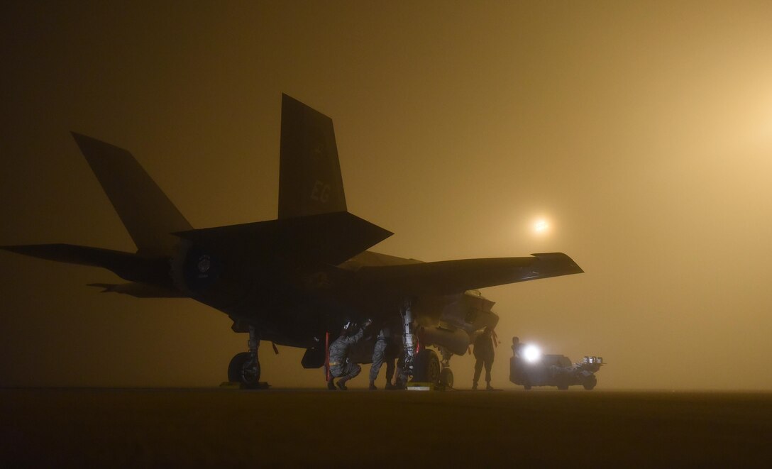A U.S. Air Force weapons load crew assigned to the 33rd Aircraft Maintenance Squadron loads a live GBU-12 into an F-35A January 18, 2017, at Eglin Air Force Base, Florida. The 33rd Fighter Wing loaded and released the Air Education and Training Command’s first live bombs from an F-35A. Six aircraft were loaded with armed GBU-12s, and two bombs were released over the Eglin Air Force Base range. (U.S. Air Force photo by Staff Sgt. Peter Thompson)