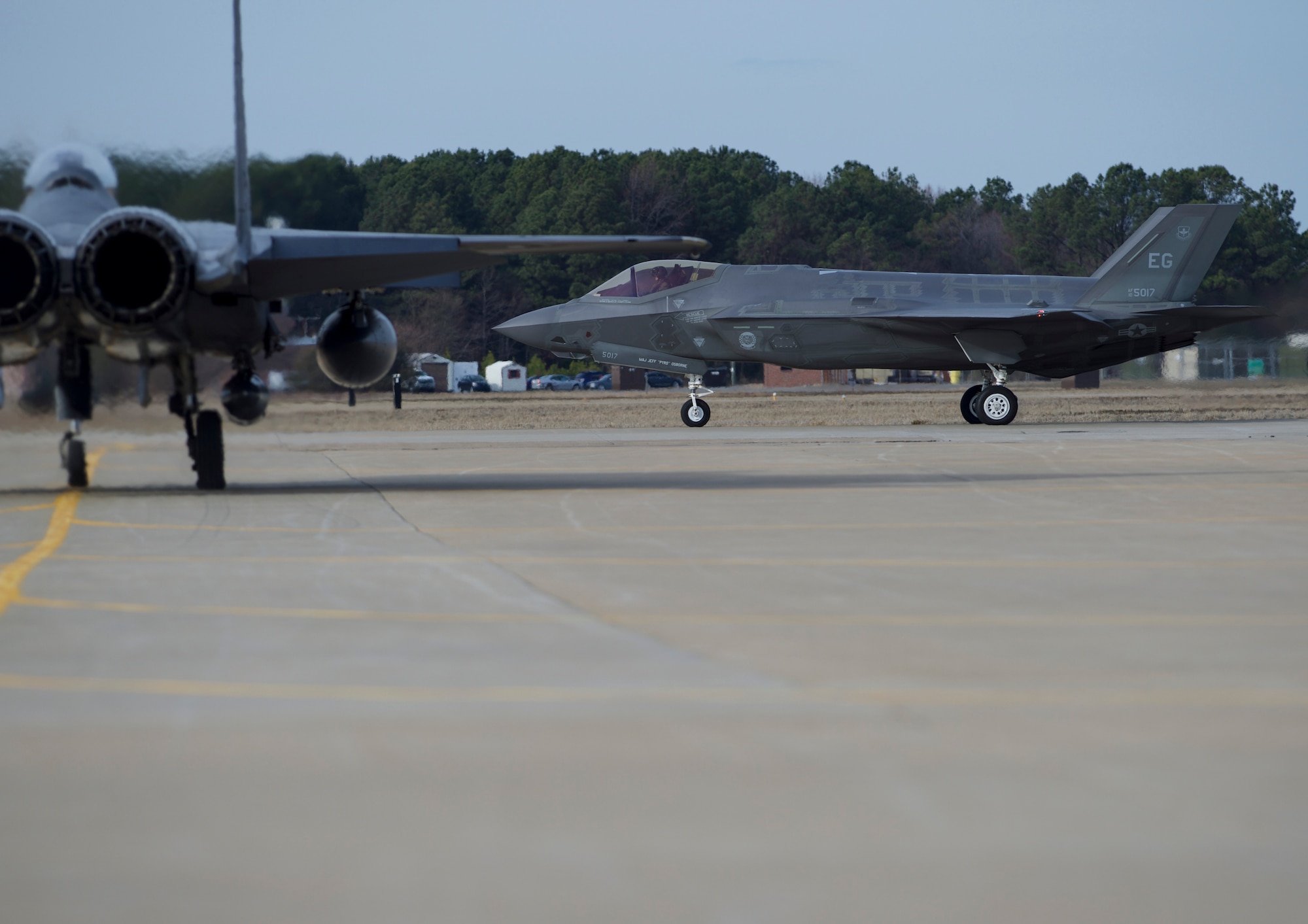 Two U.S. Air Force fighter jets taxi to take off for practice for an inauguration flyover at Joint Base Langley-Eustis, Va., Jan. 19, 2017. Two generations of fighter aircraft are scheduled to fly in a close formation during the inauguration of President-elect Donald J. Trump at the Capitol in Washington, District of Columbia, Jan. 20, 2017. (U.S. Air Force photo by Airman 1st Class Derek Seifert)