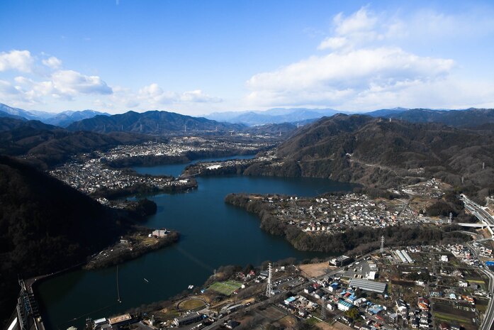 The view from the inside of a UH-1N Iroquois as it flies over a lake near Mt. Fuji, Japan, during a training mission Jan. 13, 2017. Members of the 459th Airlift Squadron complete hoist training at a landing zone near Mt. Fuji. (U.S. Air Force photo by Staff Sgt. David Owsianka)