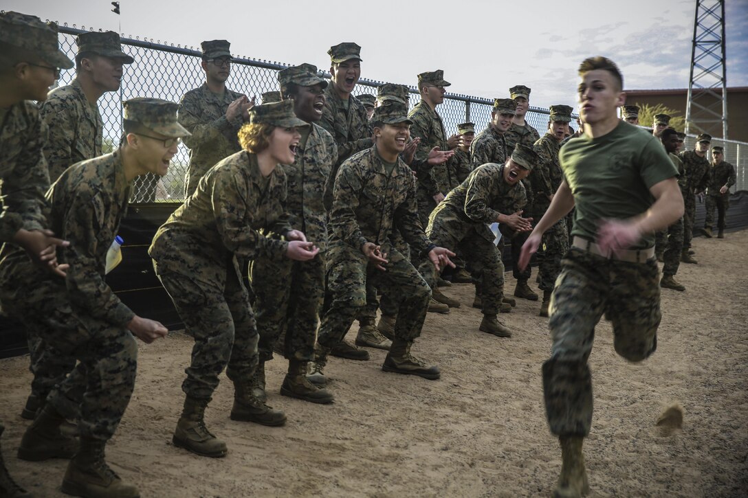 Marines cheer on a fellow Marine during a relay as part of the "Super Squadron" competition at Marine Corps Air Station Yuma, Ariz., Jan. 13, 2017. The Marines are assigned to Marine Air Control Squadron 1. Marine Corps photo by Lance Cpl. George Melendez