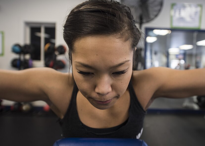 U.S. Air Force Staff Sgt. Sheena Raya Amaya, a 35th Aerospace Medicine Squadron aerospace medical technician, completes 20 lateral raises in the Potter Fitness Center at Misawa Air Base, Japan, Jan. 12, 2017. The number of repetitions will vary depending on an individual's fitness goals of either size, strength or endurance. (U.S. Air Force photo by Tech. Sgt. Araceli Alarcon)