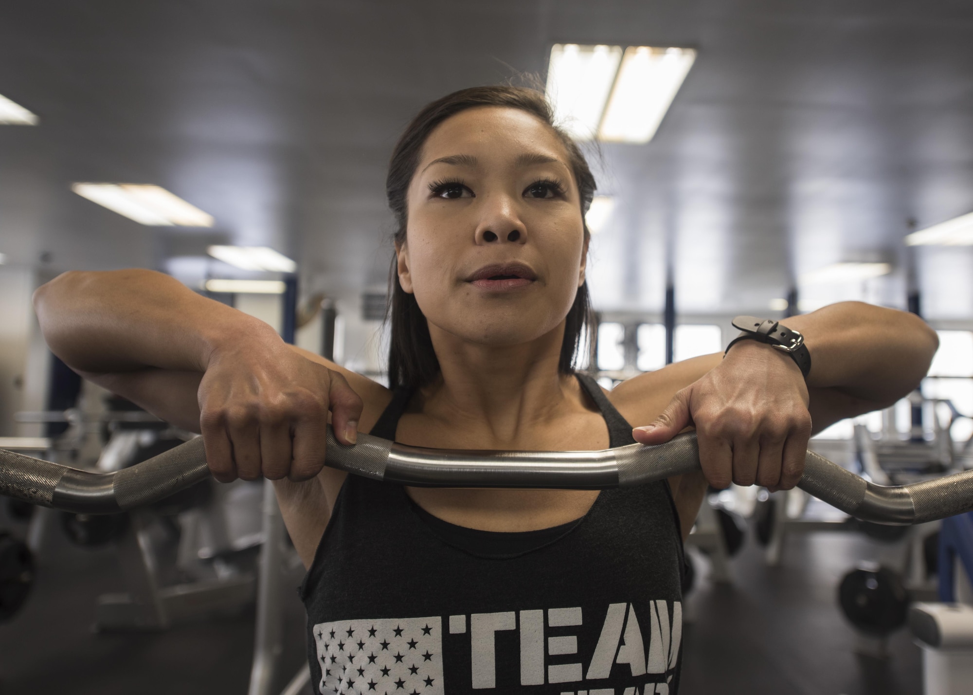 U.S. Air Force Staff. Sgt. Sheena Raya Amaya, a 35th Aerospace Medicine Squadron aerospace medical technician executes standing upright rows in the Potter Fitness Center at Misawa Air Base, Japan, Jan. 12, 2017. Amaya motivates other figure and bodybuilder competitors through fitness and is involved with non-profit veteran fitness organizations. (U.S. Air Force photo by Tech. Sgt. Araceli Alarcon)