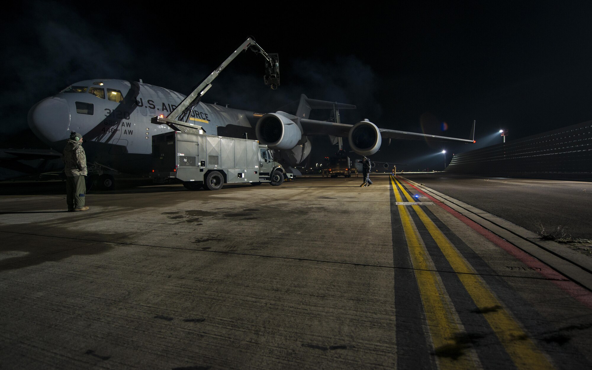 U.S. Air Force Reserve Airmen assigned to the 349th and 945th Aircraft Maintenance Squadrons prepare to spray propylene glycol onto a C-17 Globemaster III at Ramstein Air Base, Germany, Dec. 9, 2016. The liquid absorbs water, which removes ice from the aircraft. Airmen from multiple Reserve aircraft maintenance squadrons are on a temporary duty assignment at Ramstein to train with the 721st AMXS. As a part of this training, many of the Airmen deice aircraft when it is required. (U.S. Air Force photo by Senior Airman Tryphena Mayhugh)