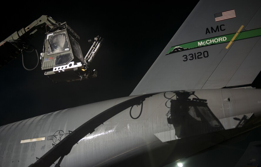 U.S. Air Force Reserve Senior Airman Brian Moolekamp, 945th Aircraft Maintenance Squadron electrical environmental systems, descends to the ground at Ramstein Air Base, Germany, Dec. 9, 2016. Moolekamp sprayed propylene glycol onto a C-17 Globemaster III to deice the aircraft before it took off. Airmen from multiple Reserve aircraft maintenance squadrons are on a temporary duty assignment at Ramstein to train with the 721st AMXS. (U.S. Air Force photo by Senior Airman Tryphena Mayhugh)
