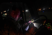 U.S. Air Force Reserve Tech. Sgt. Paul Stibbe, 446th Maintenance Squadron C-17 Globemaster III crew chief, logs the time he and other Airmen completed spraying propylene glycol onto a C-17 at Ramstein Air Base, Germany, Jan. 19, 2017. Airmen from multiple Reserve aircraft maintenance squadrons are on a temporary duty assignment at Ramstein to train with the 721st AMXS. (U.S. Air Force photo by Senior Airman Tryphena Mayhugh)