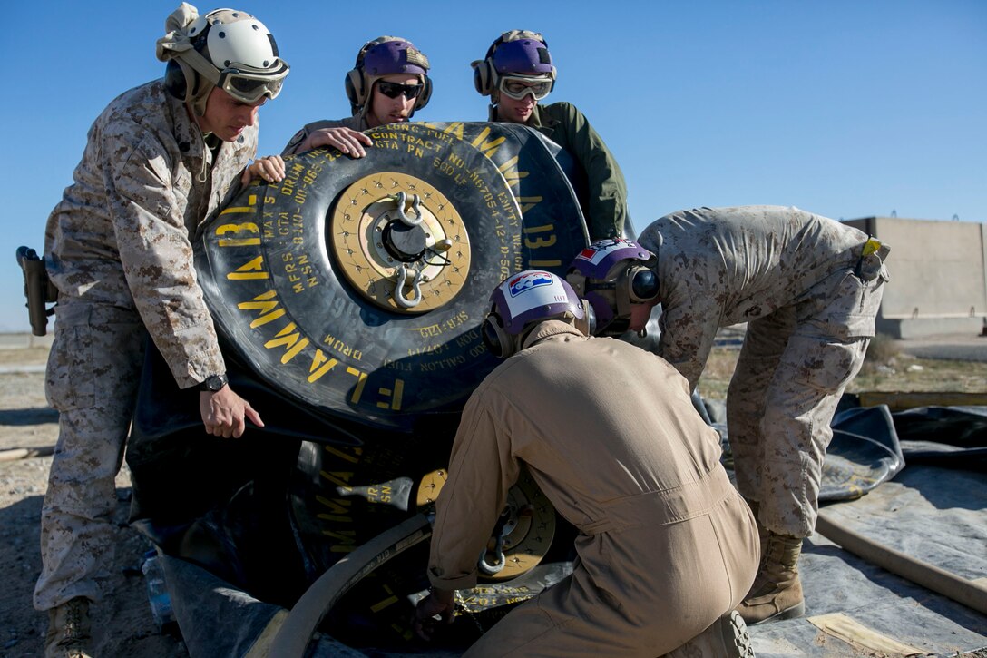 U.S. Marines with Marine Wing Support Squadron 371, Special Purpose Marine Air-Ground Task Force-Crisis Response-Central Command, tilt a fuel bladder for their helicopter expedient refueling system while forward deployed in the Middle East, Jan. 6, 2017. This system allows for aircraft to refuel almost anywhere on the battlefield, and extends the reach of the SPMAGTF’s crisis response capabilities far beyond their normal area of operation. 