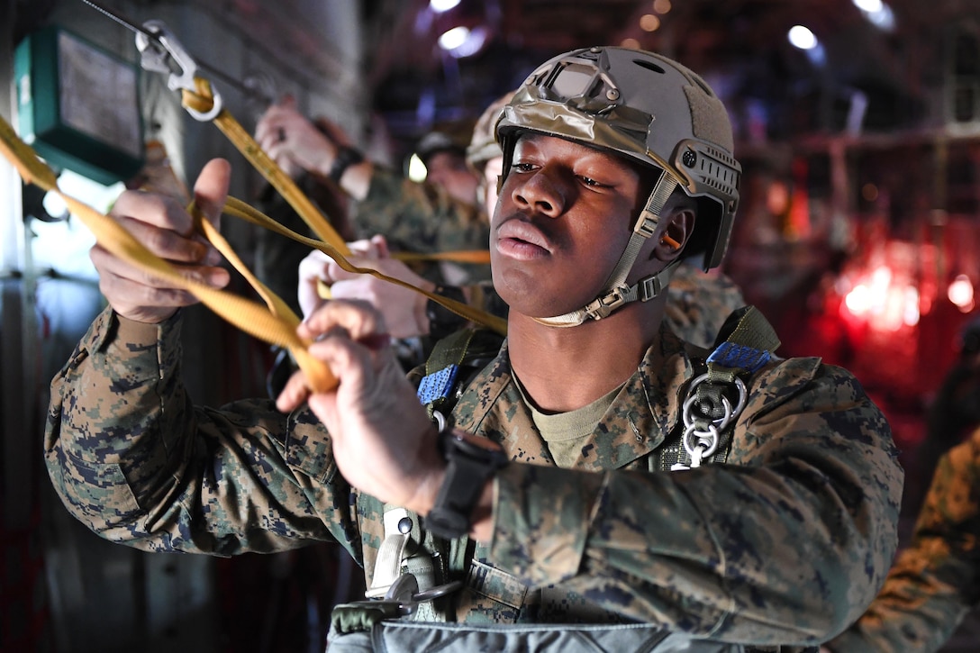 A Marine prepares to participate in a static line parachute jump from a C-130 Hercules over Yokota Air Base, Japan, Jan. 11, 2017. Air Force photo by Airman 1st Class Donald Hudson