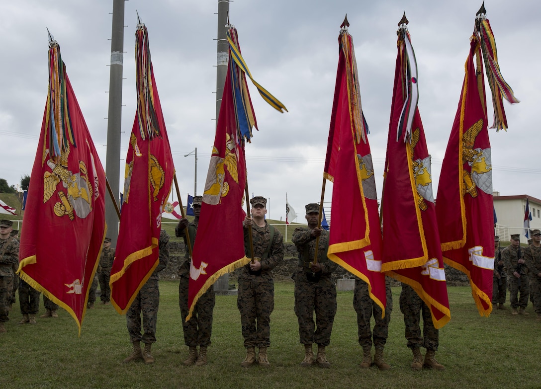 U.S. Marines carry the Marine Corps colors during a change of command ceremony for 3rd Marine Division on Camp Courtney, Okinawa, Japan, Jan. 20, 2017. Maj. Gen. Richard L. Simcock II relinquished command to Maj. Gen. Craig Q. Timberlake.