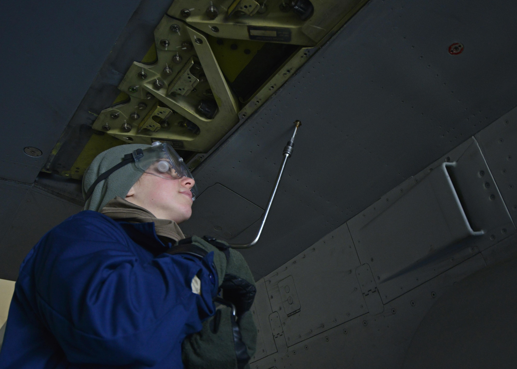 Airman Rachel Price, 31st Maintenance Squadron Aircraft Fuel Systems apprentice, unscrews a bolt on an F-16 Fighting Falcon at Aviano Air Base, Italy on Jan. 18, 2017. After panels are removed, the Airmen examine the structure of the internal fuel lines for deficiencies. (U.S. Air Force photo by Senior Airman Cary Smith)