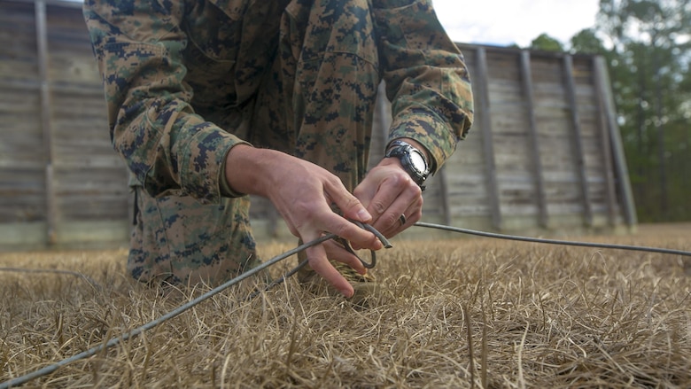 Sgt. Keith Lowe ties a knot of detonating cord while conducting a low-order demolition range at Camp Lejeune, N.C., Jan. 17th, 2017. The range was conducted to enable the Marines to be more capable of detonating unexploded ordnance without releasing shrapnel. Lowe is an explosive ordnance technician with 2nd Explosive Ordnance Disposal Company S.