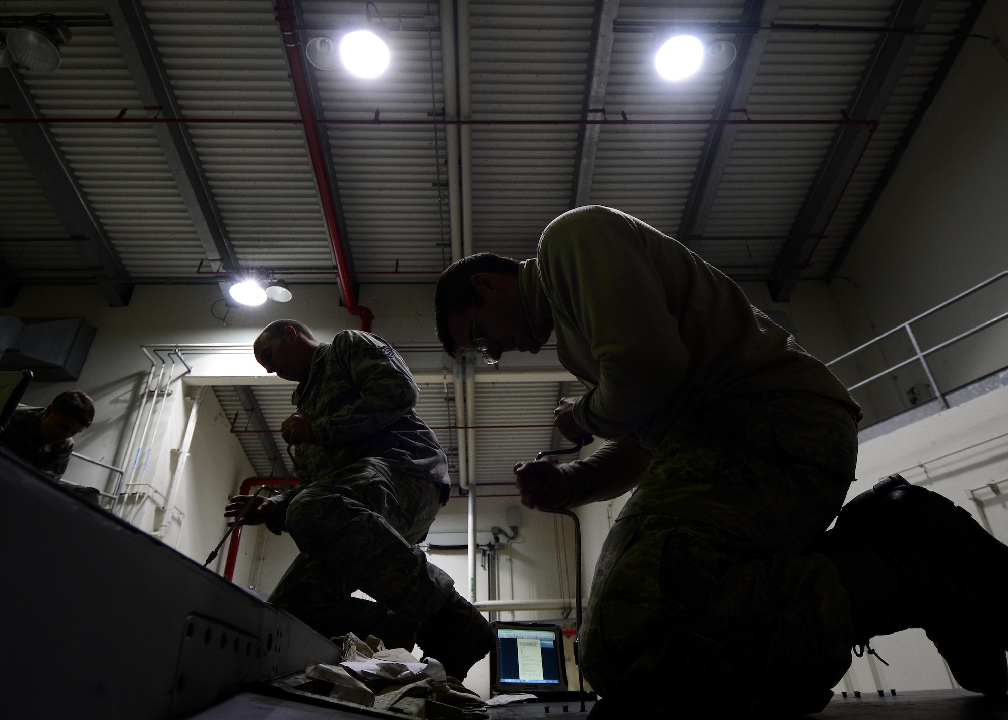 Airmen from the 31st Maintenance Squadron Aircraft Fuel Systems flight remove panels on an F-16 Fighting Falcon at Aviano Air Base, Italy on Jan. 18, 2017. After panels are removed, Airmen examine the structure of the internal fuel lines for any cracks or leaks. (U.S. Air Force photo by Senior Airman Cary Smith)