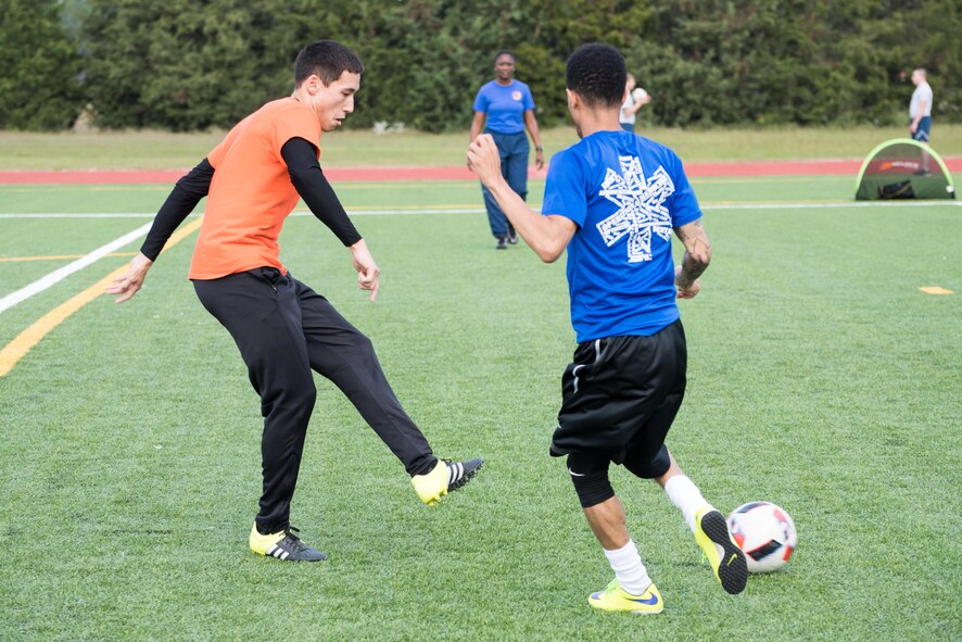 Senior Airman Benjamin Latimer, assigned to the 43d Air Base Squadron at Pope Field, was recently selected for the Conseil International du Sport Militaire team as a representative of the U.S. Armed Forces, and is currently competing in the 2017 CISM Soccer Championship in Muscat, Oman, which continues through Jan. 29. Here, Latimer (left) passes the ball during the 43d Air Mobility Operations Group Sports Day competition in October 2016. He also played previously for the Air Force soccer team. (U.S. Air Force photo/Marc Barnes)
