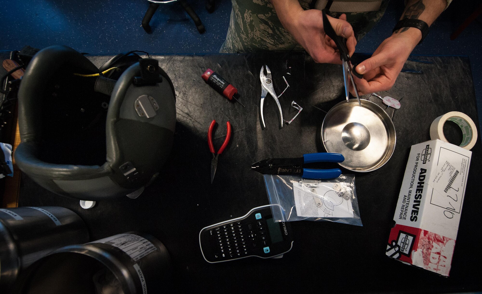 Airman 1st Class Hayden Pickett, 86th Operations Support Squadron aircrew flight equipment technician, repairs a flight helmet at Ramstein Air Base, Germany, Jan. 19, 2017. Attention to detail is key for AFE Airmen; they repair, test, and inspect all flight equipment and must ensure it is fully operational for aircrew in everyday and emergency situations. (U.S. Air Force photo by Airman 1st Class Lane T. Plummer)