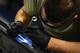 U.S. Air Force Airman 1st Class Michael Tilton, 20th Equipment Maintenance Squadron armaments technician, uses a wire brush to clean a striker point from a LAU-129 launcher at Shaw Air Force Base, S.C., Jan. 20, 2017. A striker point emits an electric signal which fires off munitions loaded onto an F-16CM Fighting Falcon. (U.S. Air Force photo by Airman 1st Class Christopher Maldonado) 