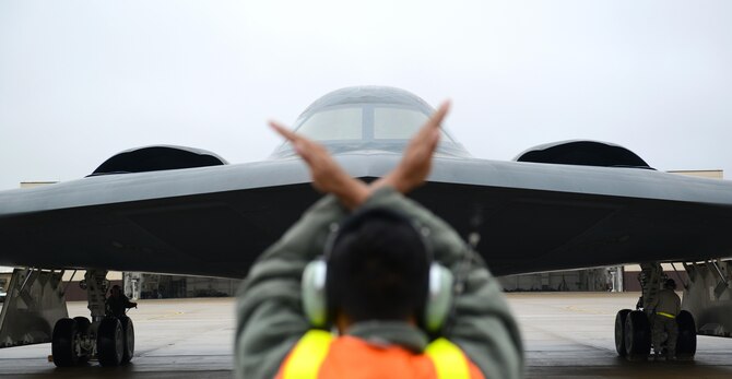 A crew chief from Whiteman Air Force Base, Mo., marshals in a B-2 Spirit stealth bomber at Whiteman Air Force Base, Mo., Jan 19, 2017. Two B-2 Spirit stealth bombers returned after flying an approximate 30-hour sortie in support of operations near Sirte, Libya. In conjunction with the Libyan Government of National Accord, the U.S. military conducted precision airstrikes Jan. 18, 2017, destroying two Daesh camps 45 kilometers southwest of Sirte. (U.S. Air Force photo by Senior Airman Joel Pfiester)