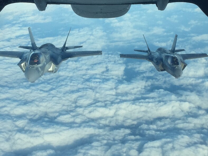 Two Marine Fighter Attack Squadron 121 F-35Bs Lightning IIs en route to Iwakuni, Japan, fly in formation after receiving fuel from a KC-10 Extender from Travis Air Force Base, Calif., Jan. 18, 2017. Air Mobility Command aerial refueling aircraft enable worldwide missions through force extension, making combat operations and partner nation support possible. (Courtesy photo)