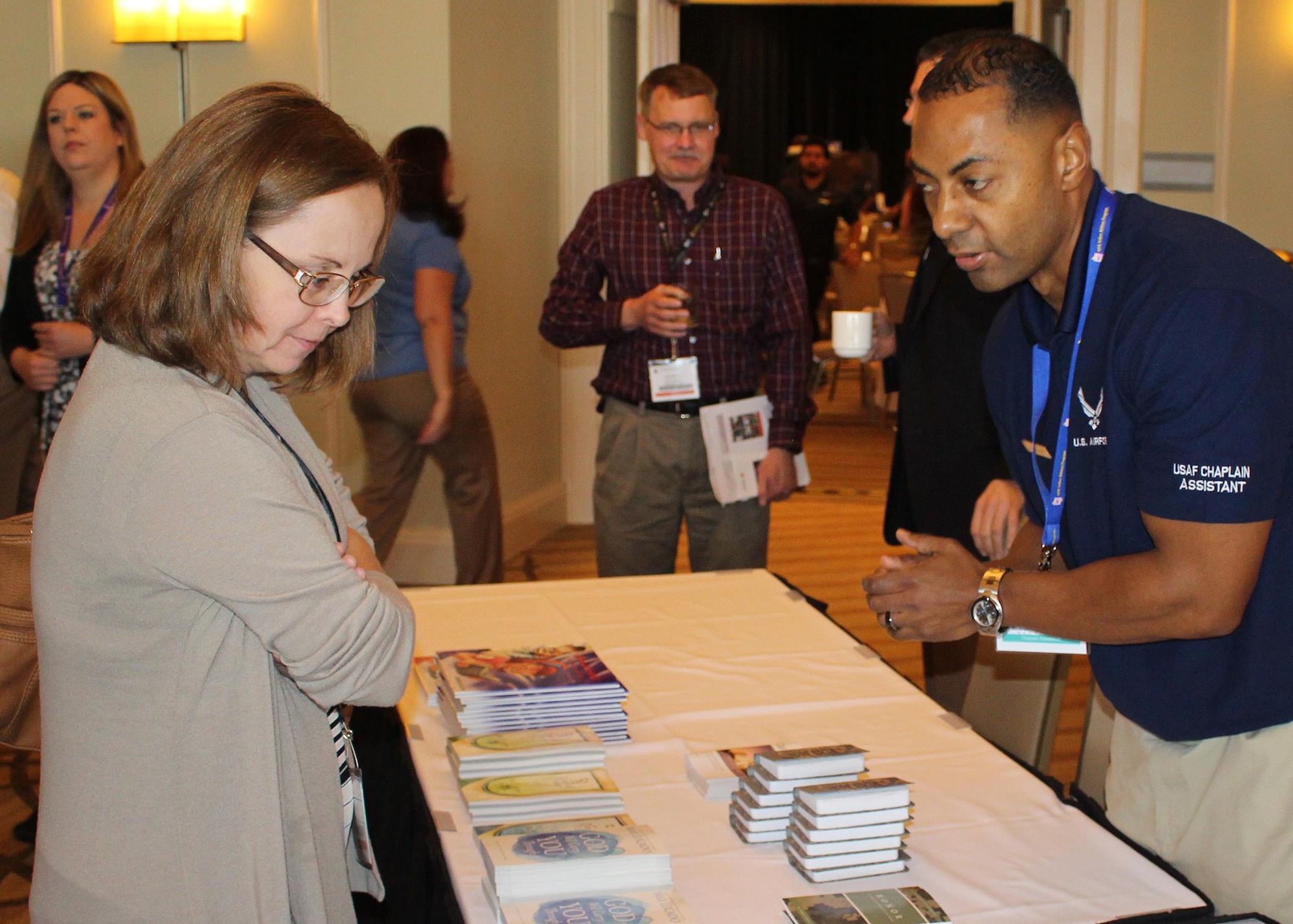 Chief Master Sgt. Jackie Larrington (left), superintendent at the 87th Aerial Port Squadron, Wright-Patterson Air Force Base, Ohio, discusses religious programs Jan. 14, 2017, with Tech. Sgt. Austin Holland, a chaplain's assistant from Sheppard Air Force Base, Texas, during a Yellow Ribbon Reintegration Program event in Naples, Florida. (U.S. Air Force photo by Chief Master Sgt. Raymond Sarracino)