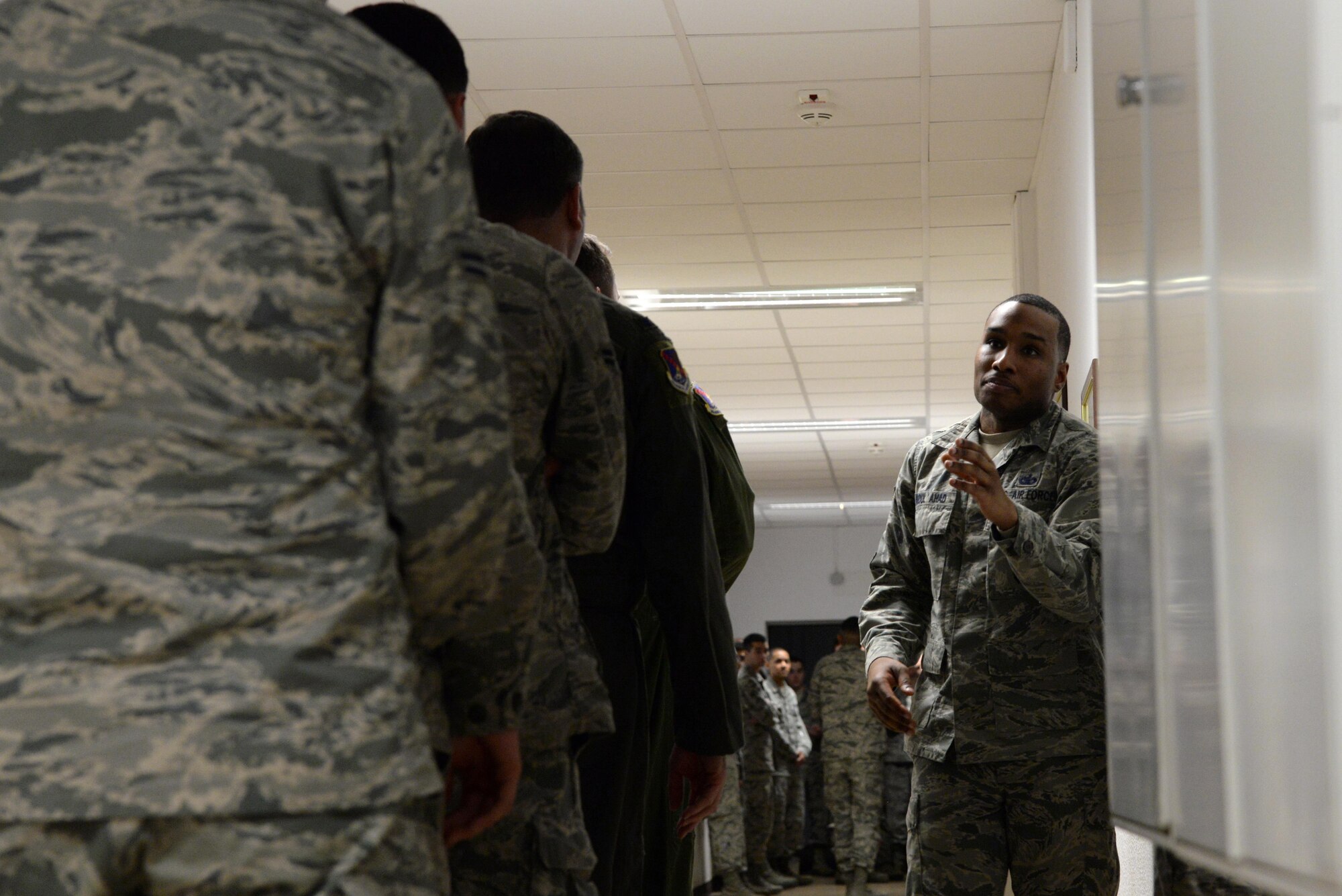 Staff Sgt. Karriem Abdulahad, 86th Security Forces Squadron training instructor, demonstrates how to correctly exit a facility during an active shooter situation at Ramstein Air Base, Germany, Dec. 15, 2016. During the EAST course Abdulahad simplifies uncommon thought processes giving Airmen the best chance for survival. (U.S. Air Force photo by Airman 1st Class D. Blake Browning)
