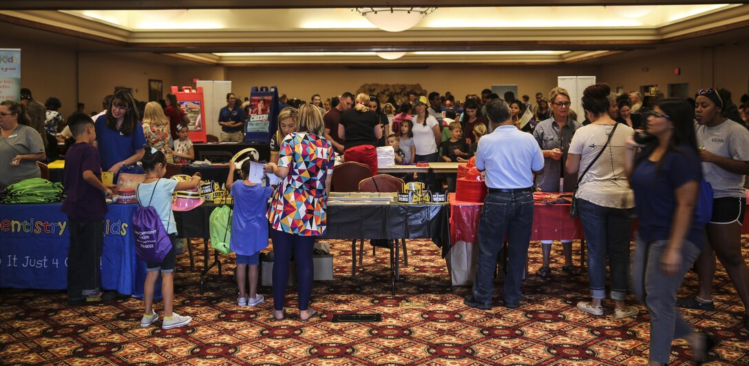 Military service members and their families enjoy the annual “Back to School Resource Fair,” hosted by the Family Care Branch at the Sonoran Pueblo aboard Marine Corps Air Station Yuma, Ariz., Tuesday, August 2, 2016. The fair gave military families a chance to meet with more than 30 community and base organizations, while receiving free school supplies.