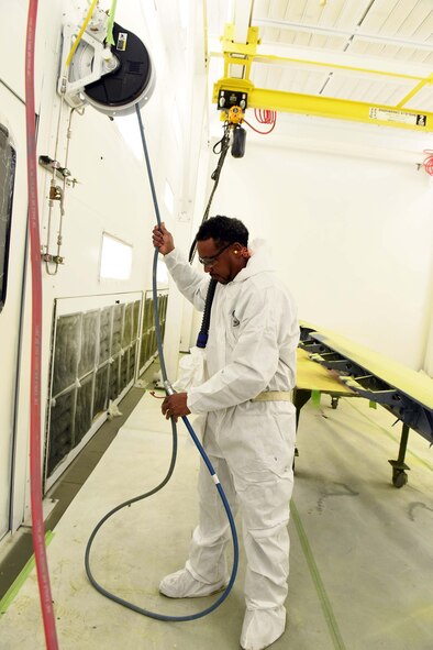 Rivers Foreman, 571st Commodities Maintenance Group aircraft painter, paints a C-130 aileron inside a recently installed state-of-the-art paint booth. Installation of three new paint booths at the facility has drastically decreased production time, work hazards, health hazards and environmental impact simultaneously. (U.S. Air Force photo by Tommie Horton)