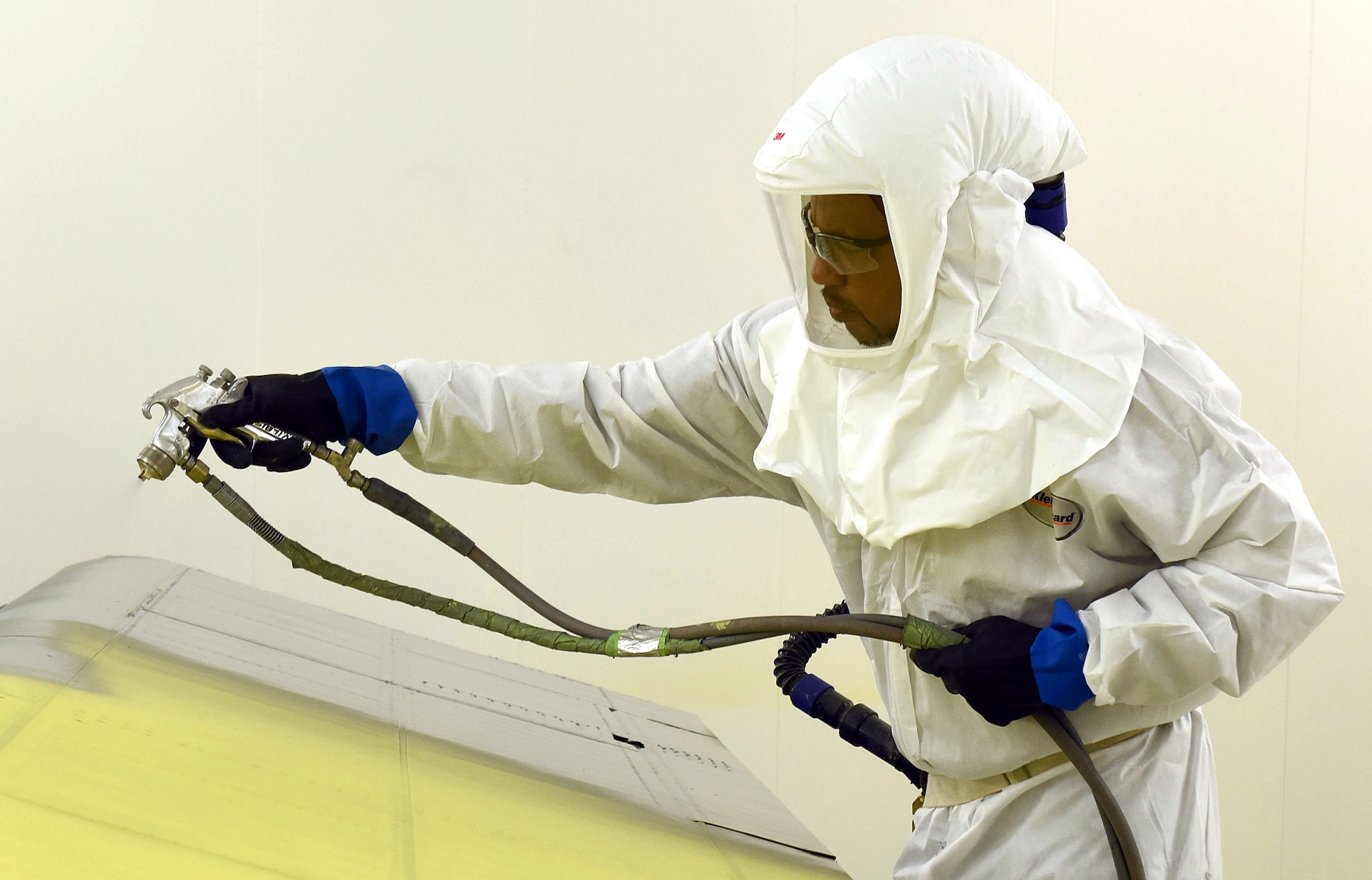 Rivers Foreman, 571st Commodities Maintenance Group aircraft painter, paints a C-130 aileron inside a recently installed state-of-the-art paint booth. Installation of three new paint booths at the facility has drastically decreased production time, work hazards, health hazards and environmental impact simultaneously. (U.S. Air Force photo by Tommie Horton)