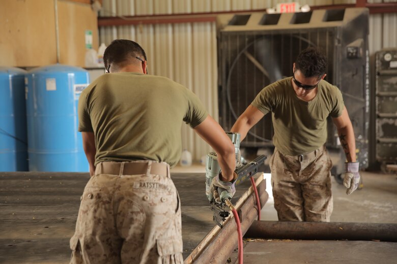 Lance Cpl. Dominic Ratsythong and Lance Cpl. Jacob Moreno, assigned through the fleet assistance program with Headquarters and Headquarters Squadron, assist with range maintenance by pre-fabricating wooden targets to support tenant and visiting commands during Weapons and Tactics Instructors course 1-17 aboard Marine Corps Air Station Yuma, Ariz., September 29, 2016.