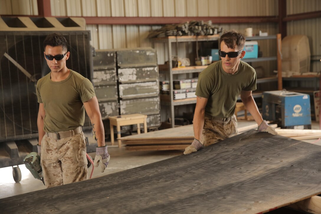 Cpl. Layton Knight and Lance Cpl. Jacob Moreno, assigned through the fleet assistance program with Headquarters and Headquarters Squadron, assist with range maintenance by pre-fabricating wooden targets to support tenant and visiting commands during Weapons and Tactics Instructors course 1-17 aboard Marine Corps Air Station Yuma, Ariz., September 29, 2016.