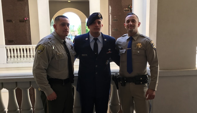 Airman 1st Class Giovanni Fiorella of the 10th Security Forces Squadron stands between brothers Dionisio Fiorella (right), a California Highway Patrol officer, and Micheal Fiorella (left), a California Department of Corrections and Rehabilitation officer. Giovanni, 22, is assigned to the 10th SFS's Elite Sentry Program at the U.S. Air Force Academy. He hopes his security force experience will help him become a civil police officer. (Courtesy photo) 