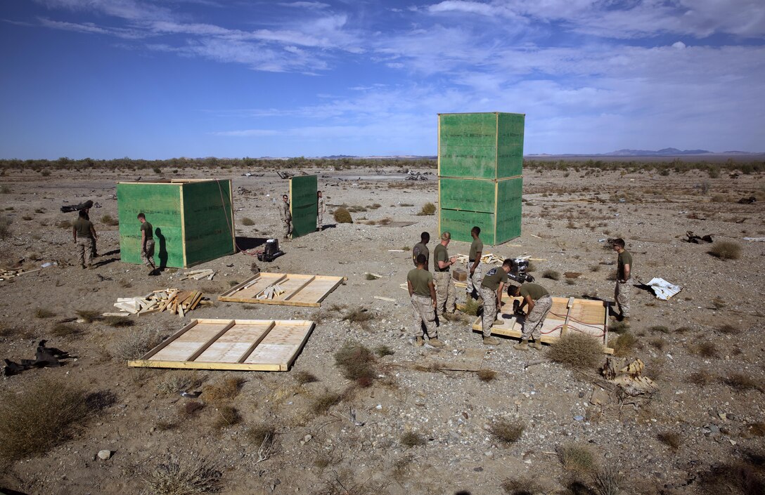 Marines assigned through the fleet assistance program with Headquarters and Headquarters Squadron, stationed at Marine Corps Air Station Yuma, Ariz., assist the range maintenance section by placing pre-assembled wooden targets in the Chocolate Mountain Aerial Gunnery Range to support Weapons and Tactics Instructors course 1-17 aboard MCAS Yuma, Ariz., Saturday, October 8, 2016.