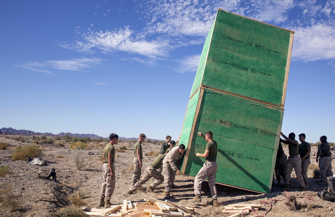 Marines assigned through the fleet assistance program with Headquarters and Headquarters Squadron, stationed at Marine Corps Air Station Yuma, Ariz., assist the range maintenance section by placing pre-assembled wooden targets in the Chocolate Mountain Aerial Gunnery Range to support Weapons and Tactics Instructors course 1-17 aboard MCAS Yuma, Ariz., Saturday, October 8, 2016.