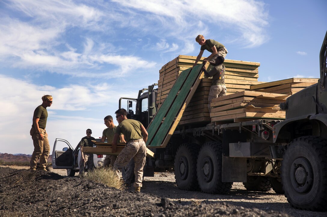 Marines assigned through the fleet assistance program with Headquarters and Headquarters Squadron, stationed at Marine Corps Air Station Yuma, Ariz., assist the range maintenance section by placing pre-assembled wooden targets in the Chocolate Mountain Aerial Gunnery Range to support Weapons and Tactics Instructors course 1-17 aboard MCAS Yuma, Ariz., Saturday, October 8, 2016.