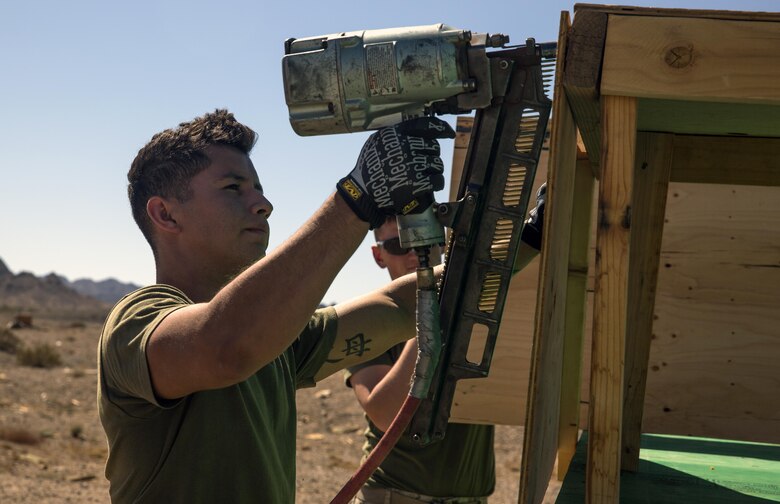 Marines assigned through the fleet assistance program with Headquarters and Headquarters Squadron, stationed at Marine Corps Air Station Yuma, Ariz., assist the range maintenance section by placing pre-assembled wooden targets in the Chocolate Mountain Aerial Gunnery Range to support Weapons and Tactics Instructors course 1-17 aboard MCAS Yuma, Ariz., Saturday, October 8, 2016 
