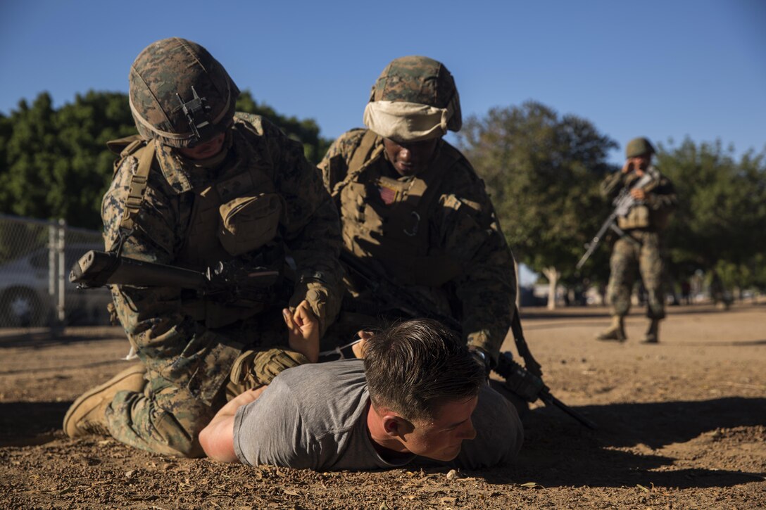 Marines with 3rd Low Altitude Air Defense Battalion, based out of Marine Corps Base Camp Pendleton, Calif., subdue a role-player at Kiwanis Park in Yuma, Ariz., during a Humanitarian Assistance/Disaster Relief (HA/DR) Exercise hosted by Marine Aviation Weapons and Tactics Squadron One during the Weapons and Tactics Instructor Course 1-17, Friday, October 14, 2016. 
