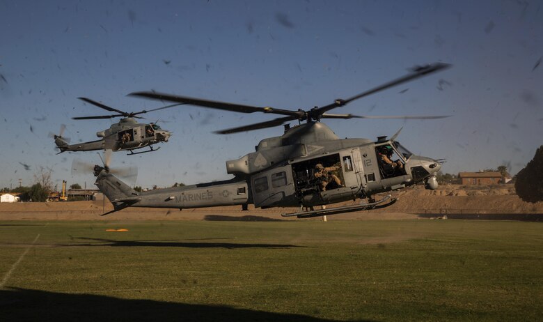 Two UH-1Y helicopters with Marine Aviation Weapons and Tactics Squadron One land to offload personnel to render aid and provide disaster relief to displaced civilians, role-players, at Kiwanis Park in Yuma, Ariz. during a Humanitarian Assistance/Disaster Relief (HA/DR) Exercise, part of the Weapons and Tactics Instructor Course 1-17, Friday, October 14, 2016. The training exercise enabled ground, aviation and support Marines and sailors to work as a team to practice deploying medical personnel, supplies, and extract personnel and people displaced from their communities.