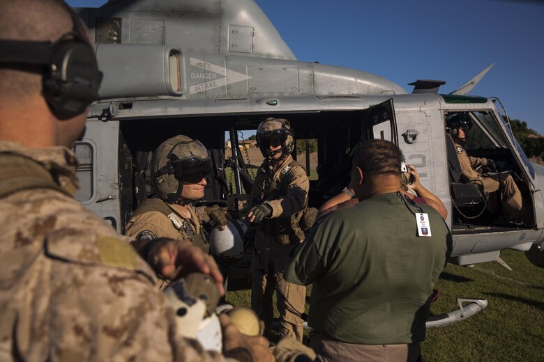 Two UH-1Y crew chiefs with Marine Aviation Weapons and Tactics Squadron One offload personnel at Kiwanis Park in Yuma, Ariz. during a Humanitarian Assistance/Disaster Relief (HA/DR) Exercise, part of the Weapons and Tactics Instructor Course 1-17, Friday, October 14, 2016. 
