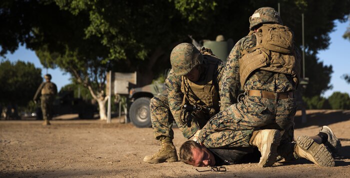Marines with 3rd Low Altitude Air Defense Battalion, based out of Marine Corps Base Camp Pendleton, Calif., subdue a role-player at Kiwanis Park in Yuma, Ariz., during a Humanitarian Assistance/Disaster Relief (HA/DR) Exercise hosted by Marine Aviation Weapons and Tactics Squadron One during the Weapons and Tactics Instructor Course 1-17, Friday, October 14, 2016.