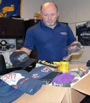 Lee McKinney, a civilian at the 470th Military Intelligence Brigade at Joint base San Antonio-Fort Sam Houston, personally packs and pays for shipping to send care packages with racing memorabilia to deployed service members worldwide.